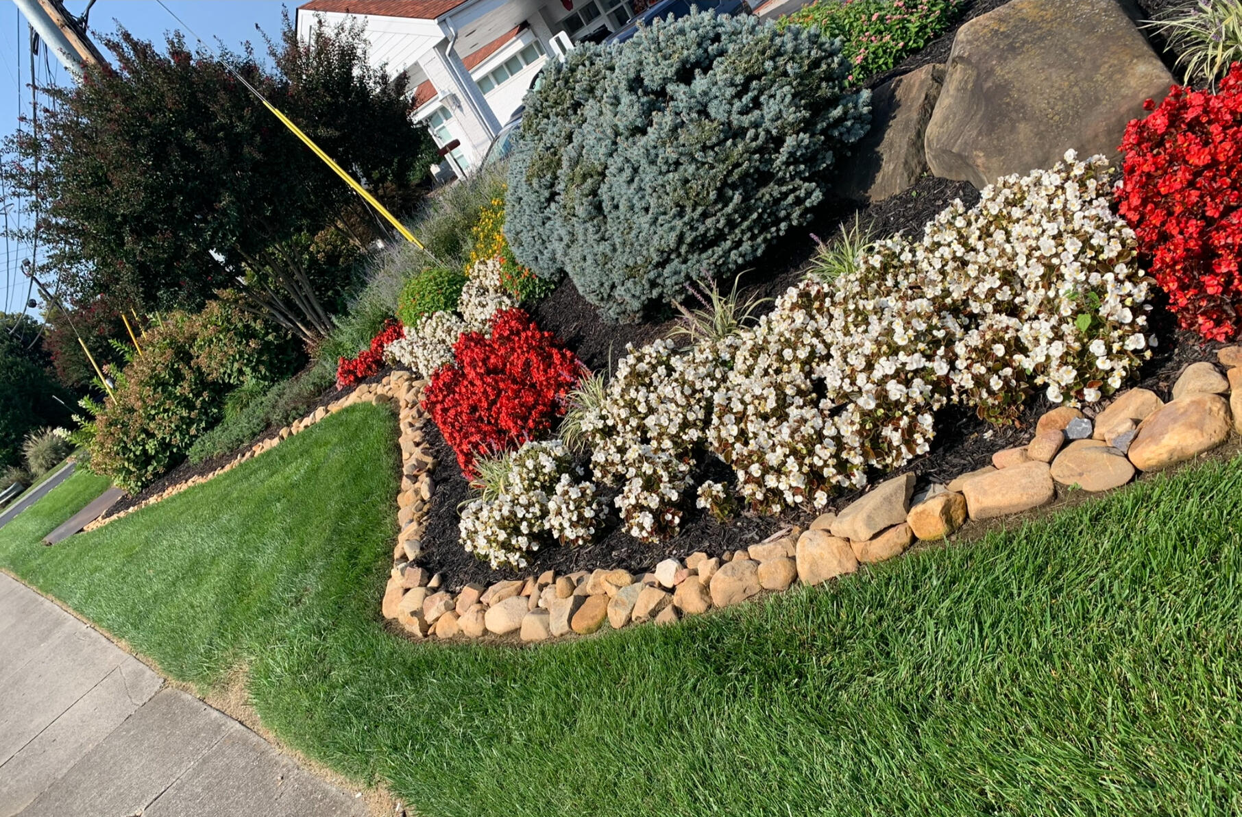 Landscaping bed with flowers and rock Landscaping and flower mulch bed